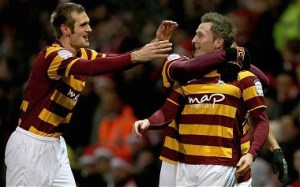 The Bradford City players celebrate knocking Arsenal out of the cup last night