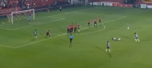 The players srt up for the freekick