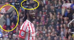 Stoke fans taunt the United fans with airplane gestures  (Image from Sky Sports)