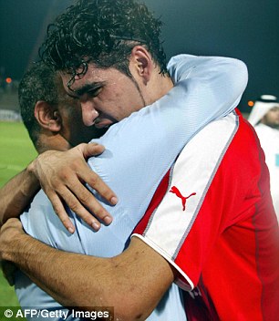 Uzbekistan players embrace after defeat sends them out of qualification (Image from AFP/Getty)